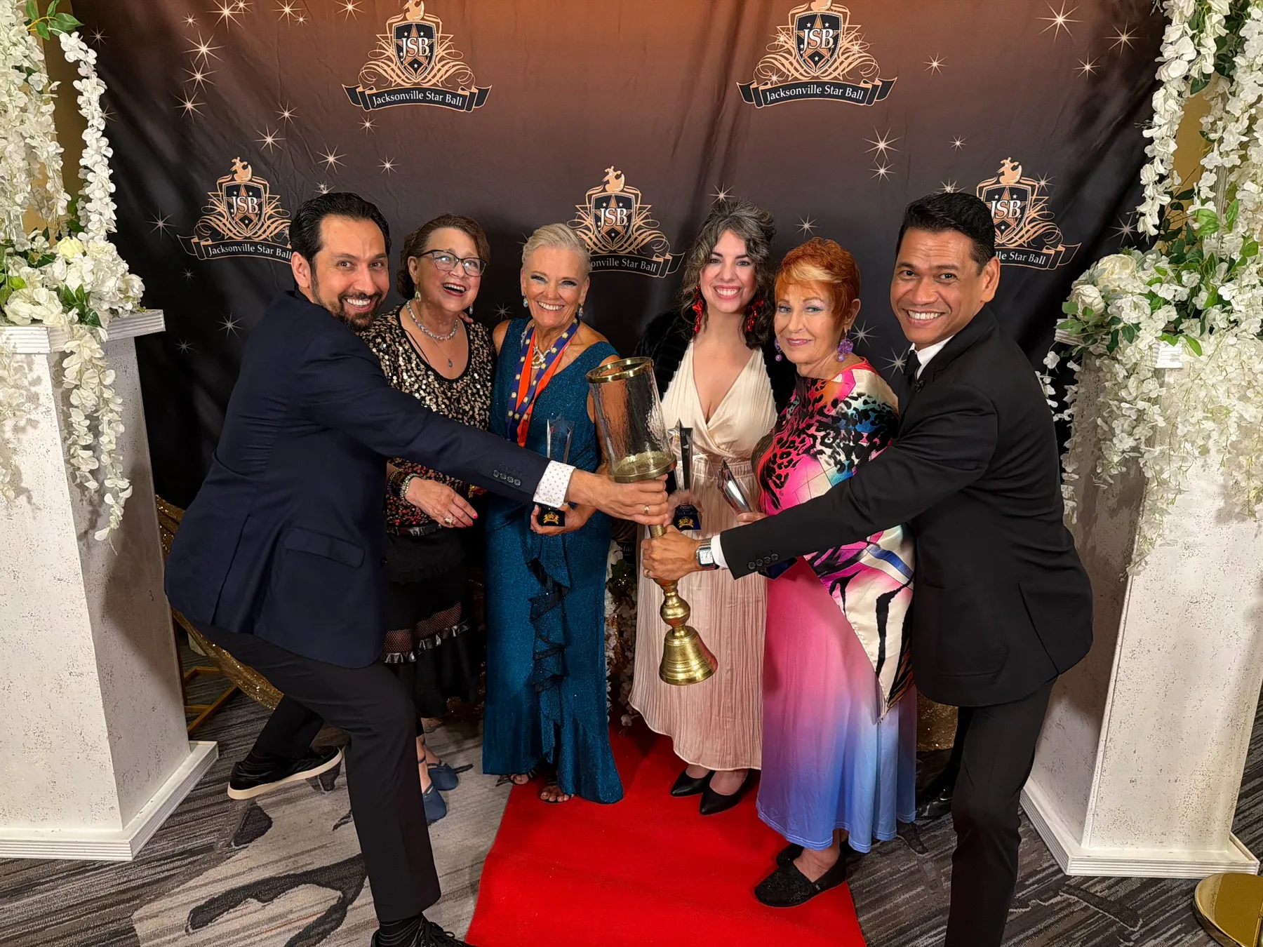 Dance Alday friends and dancers celebrating with a trophy at the Jacksonville Star Ball