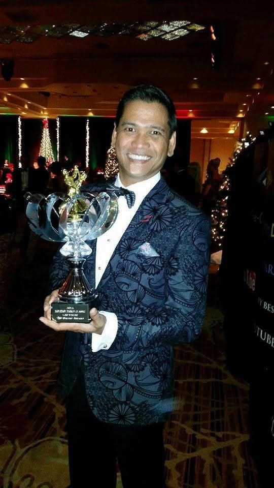 Allan Alday holding a trophy in formalwear